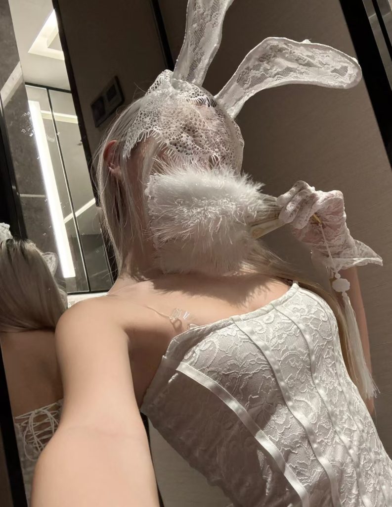 White lace bunny-girl outfit with lace mask and long ears, posed indoors – Brothel Burwood style imagery